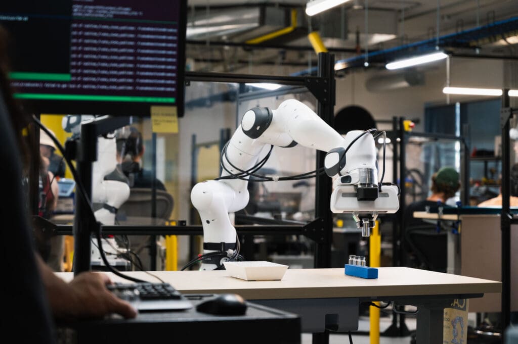 Sanctuary AI robotic arm placing parts in blue container